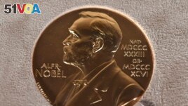 FILE - A Tuesday, Dec. 8, 2020 file photo of a Nobel medal displayed during a ceremony in New York.