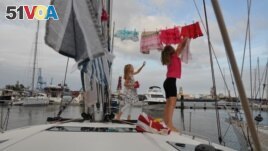 Katalin Bosze and Boroka Bosze hang their clothes to dry on the sailing boat 'Teatime' in Las Palmas, Spain. Picture taken on October 5, 2020. (Sailingteatime via Reuters)