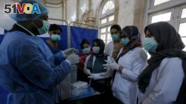 FILE - Paramedic staff attend a training session at a center newly setup for upcoming COVID-19 vaccination, in Karachi, Pakistan, Saturday, Jan. 30, 2021. Pakistan officials have set up centers in all districts of the country to administer COVID19 vaccines, which will start soon.