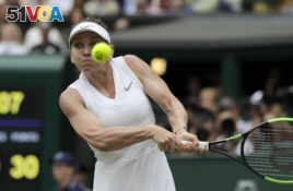 Romania's Simona Halep returns the ball to United States' Serena Williams during the women's singles final match on day twelve of the Wimbledon Tennis Championships in London, Saturday, July 13, 2019. Halep won the championship.(AP Photo/Ben Curtis)