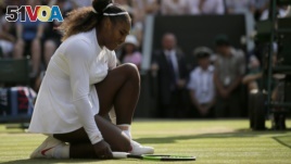 FILE - Serena Williams of the United States kneels after losing a point to Germany's Angelique Kerber during their women's singles final match at the Wimbledon Tennis Championships, in London, July 14, 2018. (AP Photo/Tim Ireland)