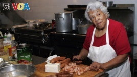 FILE - In this Jan. 20, 2009, file photo, Chef Leah Chase, owner of Dooky Chase' prepares for lunch at her restaurant in New Orleans. Chase was lovingly known as the 