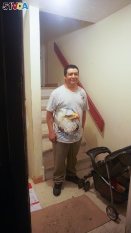 Shown standing at the entrance to his apartment, Guillermo Peralta was arrested by immigration agents on his way to work last February.