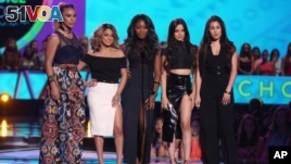 FILE - Dinah Jane Hansen, from left, Ally Brooke, Normani Kordei, Camila Cabello and Lauren Jauregui, of Fifth Harmony, present the Choice Style Icon award at the Teen Choice Awards at the Galen Center in Los Angeles, Aug. 16, 2015.