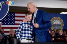FILE - Democratic presidential candidate Joe Biden kisses Brayden Harrington, 12, at a campaign stop Feb. 10, 2020, in Gilford, N.H. Biden and Harrington talked about their struggle with stuttering.