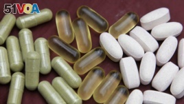 Echinacea, left, fish oil, center, and glucosamine pills.