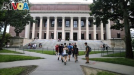 FILE - In this Aug. 13, 2019 file photo, students walk near the Widener Library in Harvard Yard at Harvard University in Cambridge, Mass. (AP Photo/Charles Krupa)
