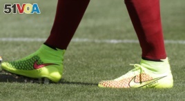 These are cleats. Many different types of athletes wear them as they grip surfaces better than smooth-soled shoes.