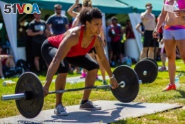 A CrossFit athlete lifts weights. (Photo: Michael J. LaPierre)
