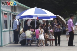 People line up to eat at a food kiosk in Pyongyang, North Korea.
