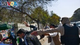 File - Taliban members violently attacked journalists during a restriction of media coverage during a women's rights protest in Kabul on October 21, 2021. (Photo by BULENT KILIC / AFP)