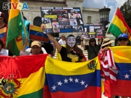 Venezuelan expats are joined by Nicaraguans, Bolivians and others during a protest calling for freedom and democracy in Venezuela, in front of the building of the Organization of American States, in Washington, May 20, 2018.