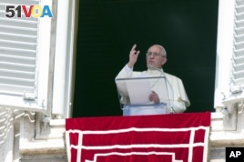 FILE - Pope Francis waves as he leads the Angelus prayer from the window of the Apostolic palace in Saint Peter's Square at the Vatican, Aug. 9, 2015.