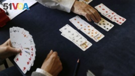  In this Tuesday, Sept. 22, 2015 file photo, competitors play bridge at the Acol Bridge Club in West Hampstead, London. A doping ban handed down to the top-ranked player in bridge has provoked a backlash in the card game. (AP Photo/Tim Ireland, File) 