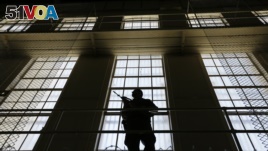 A guard stands watch over the east block of death row at San Quentin State Prison, Aug. 16, 2016, in San Quentin, Calif.