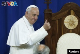 Pope Francis gestures to prisoners at Curran-Fromhold Correctional Facility in Philadelphia, Sept. 27, 2015.  