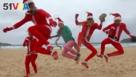 British travelers kick up their heels as they celebrate Christmas Day at Bondi Beach in Sydney, Australia, December 2012. (AP Photo/Rick Rycroft)