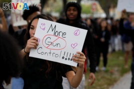 Students from South Plantation High School carrying placards and shouting slogans walk on the street during a protest in support of the gun control, following a mass shooting at Marjory Stoneman Douglas High School