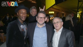 FILE - Singer Jon Bon Jovi photobombs a group photo of, from left, Aloe Blacc, Lucian Grainge and Irving Azoof at a gala in Nov. 5, 2015. (Photo by Matt Sayles/Invision for City of Hope/AP Images)