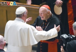 FILE - In this Sept. 23, 2015 file photo, Pope Francis reaches out to hug Cardinal Archbishop emeritus Theodore McCarrick after the Midday Prayer of the Divine with more than 300 U.S. Bishops at the Cathedral of St. Matthew the Apostle in Washington.