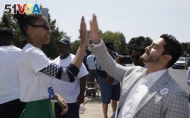 Dr. Abdul El-Sayed high-fives supporter Sonique Watson in Detroit, Aug. 8, 2017. Perhaps no state has embraced the political outsider as much as Michigan. But El-Sayed, a 32-year-old liberal doctor, is putting that affinity for newcomers to the test by mo