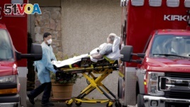 Medical workers push a man on a stretcher into an ambulance at the Life Care Center of Kirkland, a long-term care facility linked to several confirmed coronavirus cases, in Kirkland, Washington, U.S. March 3, 2020.