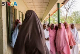 Students from Dapchi girls school return to school for the first day after Boko Haram invaded the campus in February, abducting more than 100 students.