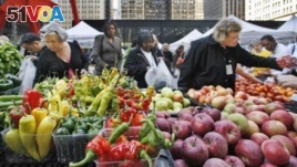 People buy fresh fruits and vegetables at an open-air farmers market in downtown Chicago. (AP Photo/M. Spencer Green)