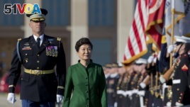 South Korean President Park Geun-hye reviews the troops during a full military honors parade to welcome her, Thursday, Oct. 15, 2015, at the Pentagon.