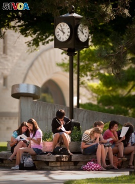 Students sit outside on the Kansas State University campus in Manhattan, Kansas.