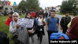 Hundreds of migrants stuck in Serbia set off on foot toward the border with Hungary to protest its closure for most people trying to reach the European Union.