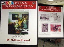 FBI posters displaying works by artists Johannes Vermeer and Edgar Degas are seen during a press conference held to appeal to the public for help in returning artwork stolen in 1990 from the Isabella Stewart Gardner Museum in Boston, Massachusetts.