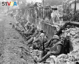 In this February 1968 file photo, U.S. Marines rest near Hue's imperial palace after a battle during the Tet Offensive.