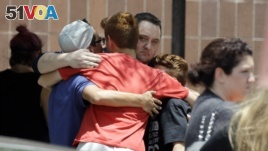 People react outside the unification center at the Alamo Gym, following a shooting at Santa Fe High School in Santa Fe, Texas.