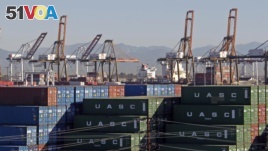 In this Feb. 12, 2015 file photo, the Port of Los Angeles, with some cargo loading cranes in the upright and idle position, are seen in this view from the San Pedro area of Los Angeles. (AP Photo/Nick Ut, File)