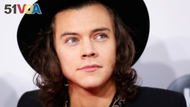 FILE - Harry Styles of One Direction arrives at the 42nd American Music Awards in Los Angeles, California.
