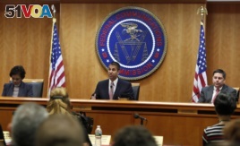 Federal Communications Commission (FCC) Chairman Ajit Pai, center, announces the vote was approved to repeal net neutrality, next to Commissioner Mignon Clyburn, left, who voted no, and Commissioner Michael O'Rielly, who voted yes, at the FCC, Dec. 14, 20