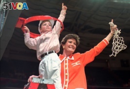FILE - Tennessee coach Pat Summitt and son, Tyler, take down the net after Tennessee defeated Georgia, 83-65, in the title game at the NCAA women's basketball Final Four at Charlotte Coliseum in Charlotte, North Carolina, March 31, 1996