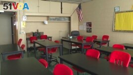 In this image made from video, an empty classroom is shown at David Ellis Academy in Detroit, Monday, Feb. 8, 2021. (AP Photo/Mike Householder File) 