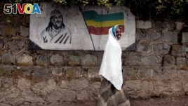 FILE: An Ethiopian woman walks past a mural depicting Ethiopia's Emperor Tewodros II in Addis Ababa, Ethiopia, June 1, 2007.