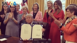 President Donald Trump at the White House, signing two laws that authorize NASA and the National Science Foundation to encourage women and girls to get into STEM fields.