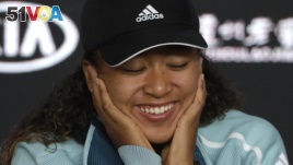 Japan's Naomi Osaka answers questions at a press conference following her win over Karolina Pliskova of the Czech Republic in their semifinal at the Australian Open tennis championships in Melbourne, Australia, Thursday, Jan. 24, 2019. 