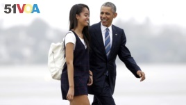 FILE - President Barack Obama and his daughter Malia walk from Marine One toward Air Force One in 2016. Malia is attending Harvard University after a gap year.
