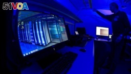 FILE - Jan. 11, 2013 file photo of a member of the Cybercrime Center as he turns on the light in a lab during a media tour at the occasion of the official opening of the Cybercrime Center at Europol headquarters in The Hague, Netherlands. (AP Photo/Peter Dejong, File)