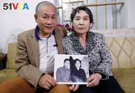Former Vietnamese chemical student Pham Ngoc Canh who studied in North Korea and his North Korean wife Ri Yong Hui hold their first photo together which was taken in Spring 1971, at their house in Hanoi, Vietnam February 12, 2019. (REUTERS/Kham)