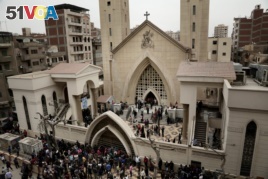 People gather outside a church in Tanta, Egypt, after a Palm Sunday bombing.