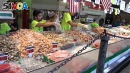 Seafood sellers at Captain White's Seafood City in Washington, DC measure different amount of their products for customers.
