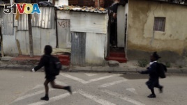 Children run to school in Alexandra township in Johannesburg, South Africa. Twenty-five years after the end of apartheid, inequality is still on display in South Africa.