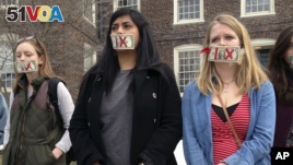 Brown University senior Maahika Srinivasan, center, of New Delhi, India, stands with senior Jeanette Sternberg Lamb, right, of Asheville, N.C., on the campus in Providence, R.I., where they organized a march to protest how the college handled recent sexua