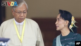 Htin Kyaw, left, newly elected president of Myanmar, walks with National League for Democracy leader Aung San Suu Kyi at Myanmar's parliament in Naypyitaw, Myanmar. (AP Photo/Aung Shine Oo)
